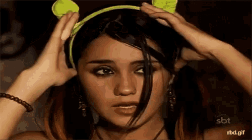 a woman is wearing a headband with ears on it