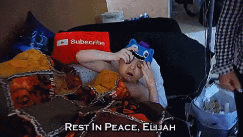 a man laying on a bed with a subscribe pillow