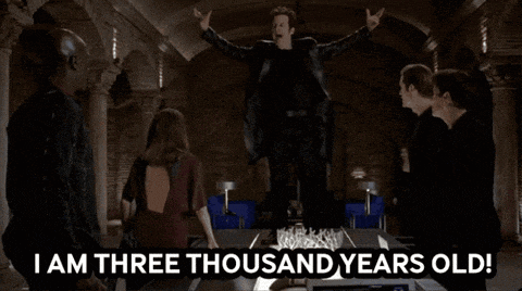a group of people standing around a table with the words " i am three thousand years old " on it