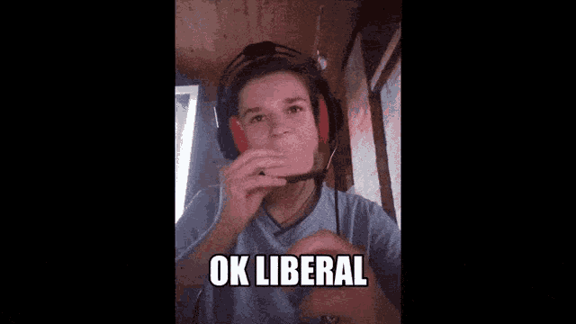 a young boy wearing headphones and a shirt that says ok liberal