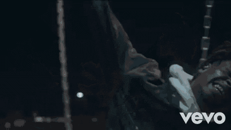 a close up of a person laying on the ground with their mouth open and screaming .