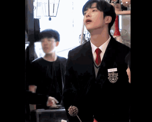 a man in a suit and tie is standing in a crowd