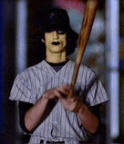 a man in a baseball uniform is holding a bat in his hand .