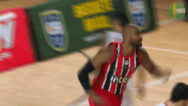 a basketball player wearing a red and black jersey that says " intel "