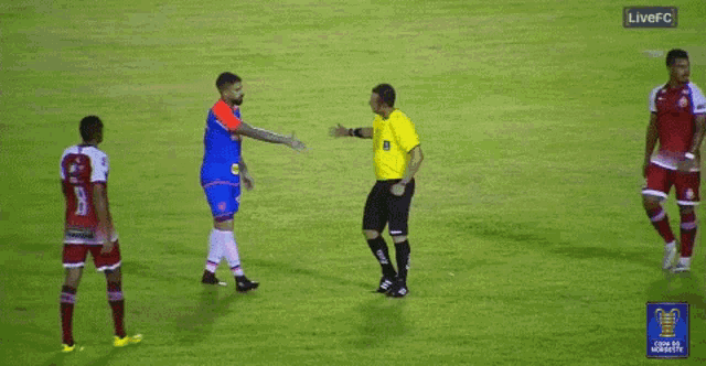 a group of soccer players on a field with a live fc sign in the corner