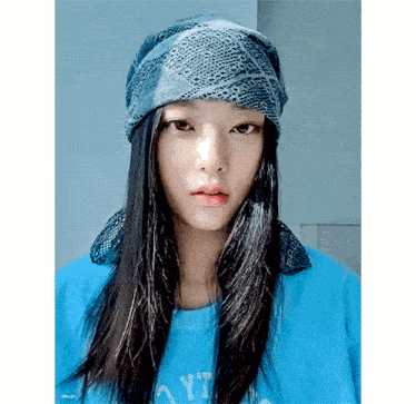 a woman wearing a bandana and a blue shirt that says yt