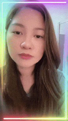 a woman 's face is surrounded by a rainbow colored frame