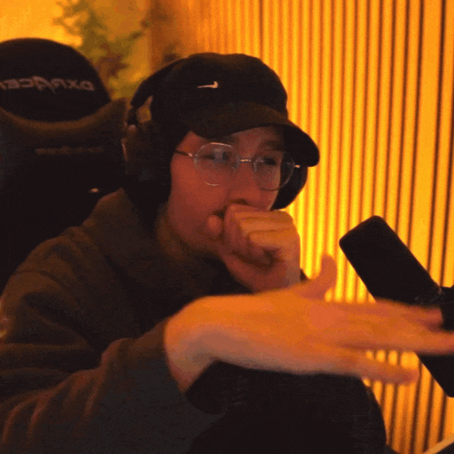 a man wearing headphones and a hat with a nike logo on it