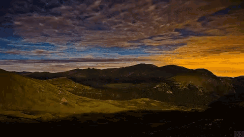 a picture of a sunset over a mountain range taken by orbd