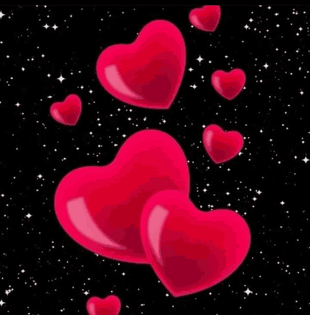 a bunch of pink hearts are floating in the air on a black background