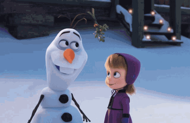 a little girl standing next to a snowman with a mistletoe sticking out of his nose