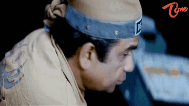 a man wearing a headband that says ' do ' on it
