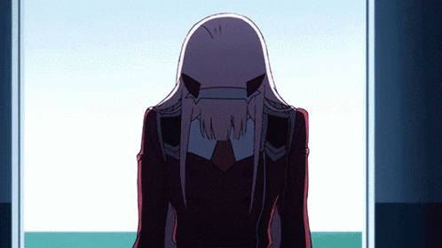 a girl with long white hair is standing in front of a door