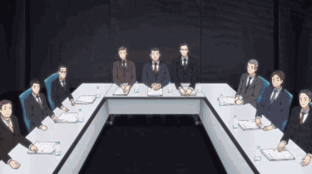 a group of men sit around a long table