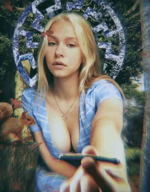 a woman in a blue shirt is holding a cigarette in her hand