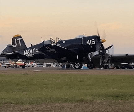a navy plane with the numbers 416 on the tail