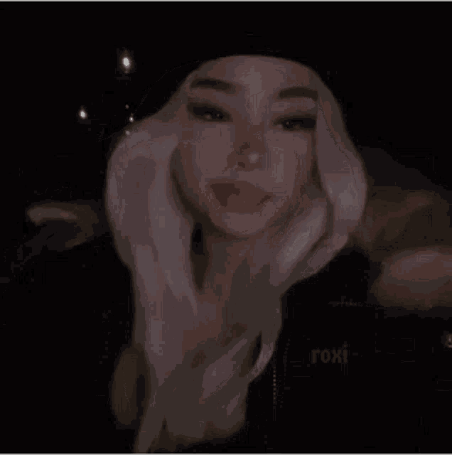 a girl with white hair wearing a black hat and a black jacket .