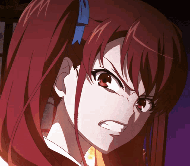 a close up of a girl with red hair making a angry face