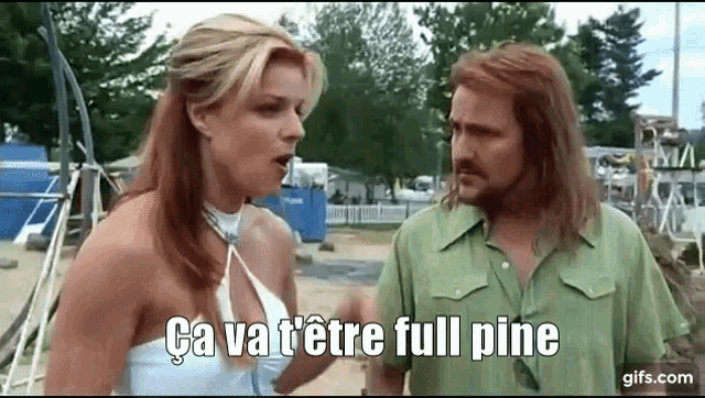 a man and a woman are standing next to each other and the woman is talking to the man .