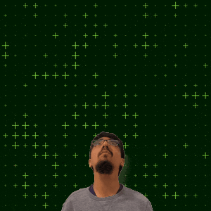 a man with glasses stands in front of a green background with the number 20