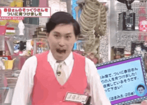 a man in a pink vest and tie is standing in front of a screen that says kaluca select on it