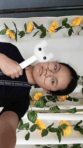 a girl wearing glasses and a black shirt that says ' sydney college of science ' on it