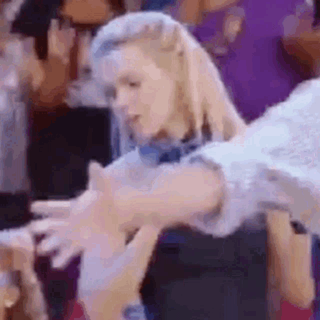 a close up of a woman dancing in a crowd .