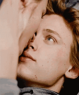 a close up of a person touching another person 's face .