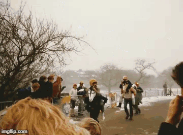 a group of people are walking down a snowy street with imgflip.com at the bottom of the screen