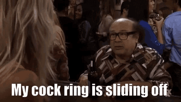 a man sitting at a table with a bottle of beer says " my cock ring is sliding off " in a crowd