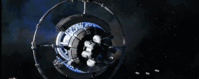 a computer generated image of a space station with a blue light coming out of the center