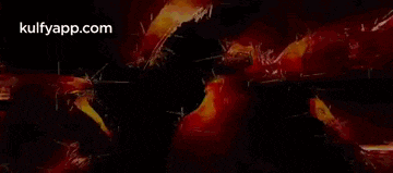 a glowing light is coming out of a hole in a dark background .