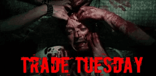a poster that says trade tuesday with a bloody man on it