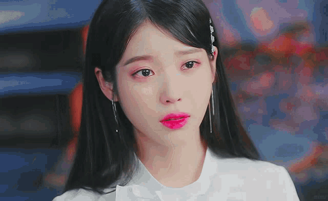 a close up of a woman 's face with a tear running down her cheek