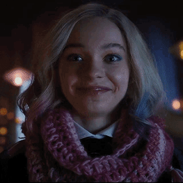 a close up of a woman wearing a scarf