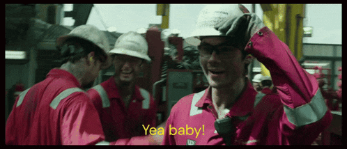 a man wearing a hard hat and a shirt that says yea baby