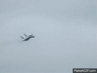 a fighter jet is flying through the air with smoke coming out of its tail .