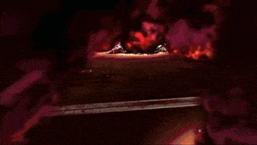 a man in a captain america costume stands in front of a fire