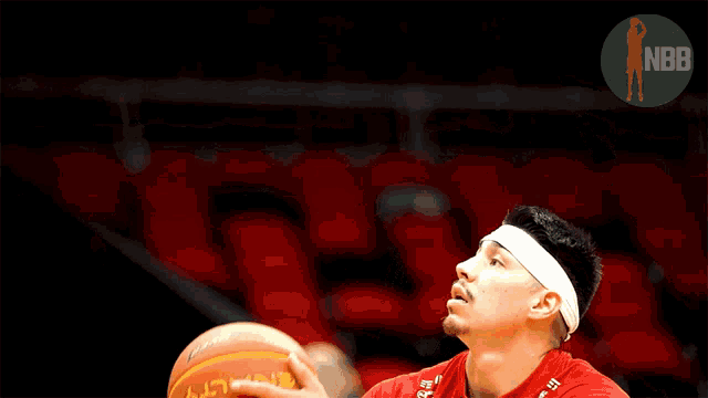 a man holding a penalty basketball in his hands
