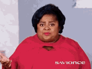 a woman is wearing a red shirt that says savionce