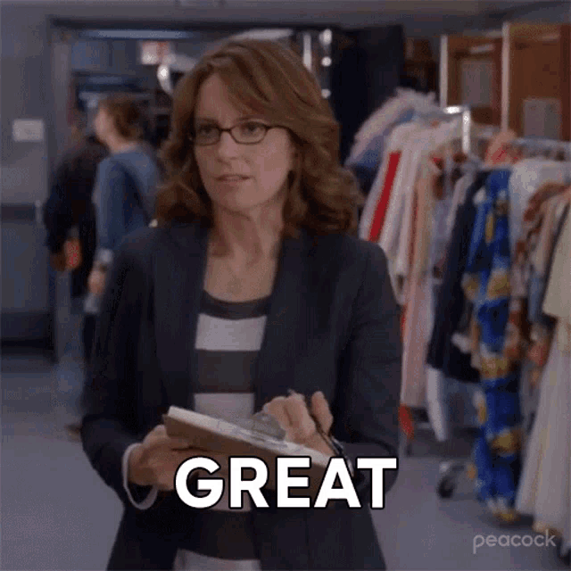 a woman with glasses is holding a clipboard and saying great