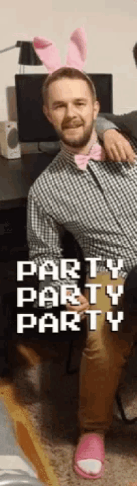 a man wearing bunny ears and a bow tie is sitting in a chair with the words party party party on the bottom