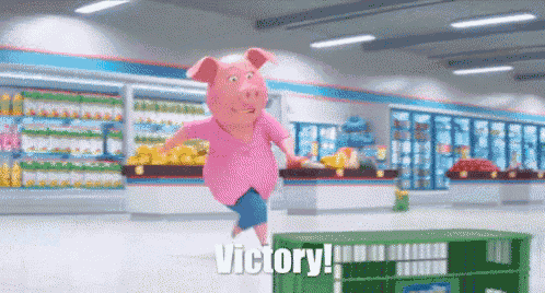 a cartoon pig is jumping over a green crate in a grocery store and saying victory .