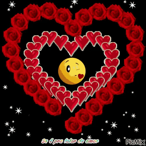 a heart made of red roses with a smiley face in the center