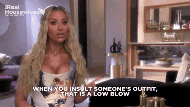 a woman says " when you insult someone 's outfit that is a low blow " in a living room