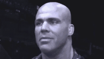 a close up of a man 's face with a bald head .