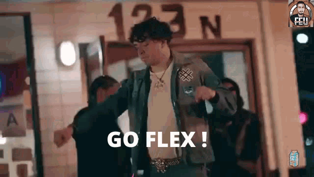 a man is dancing in front of a building with the words `` go flex '' written on the bottom .