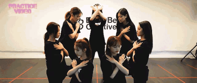 a group of women are dancing in front of a practice video sign