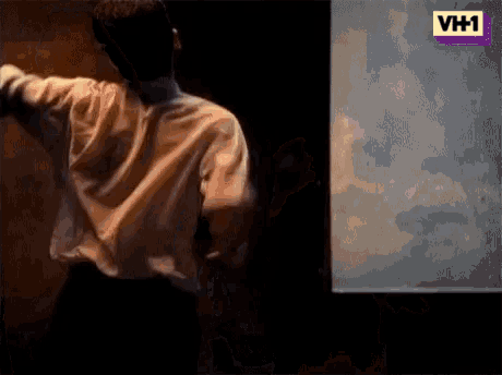 a man in a white shirt is dancing in front of a vh1 logo