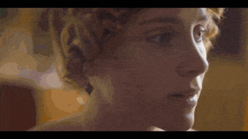 a close up of a woman 's face with a dark background
